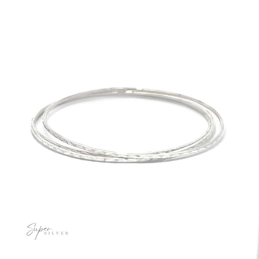 
                  
                    A pair of Sparkling Faceted Bangle Bracelets against a minimal white background.
                  
                