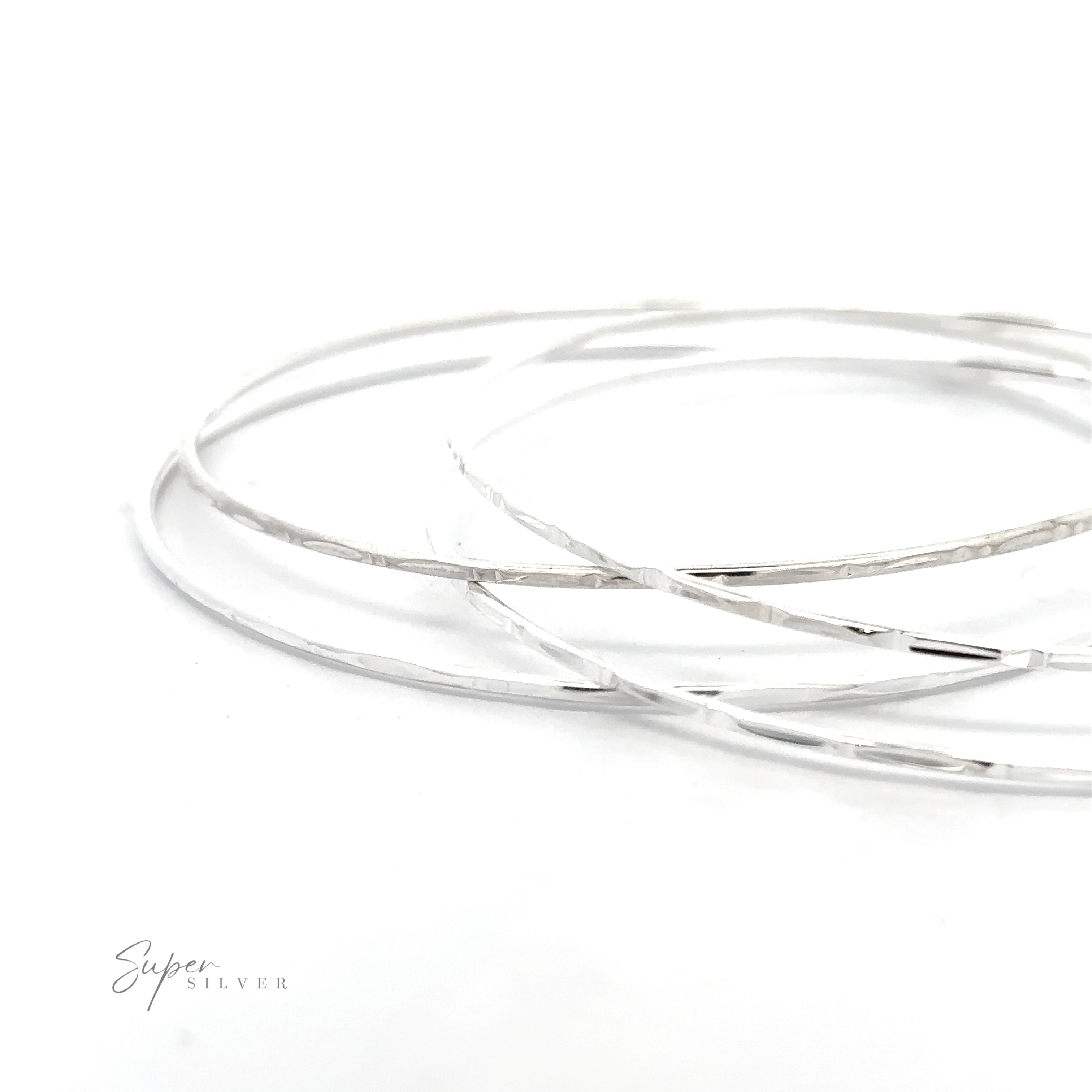 Three Sparkling Faceted Bangle Bracelets with a minimal vibe on a white surface.
