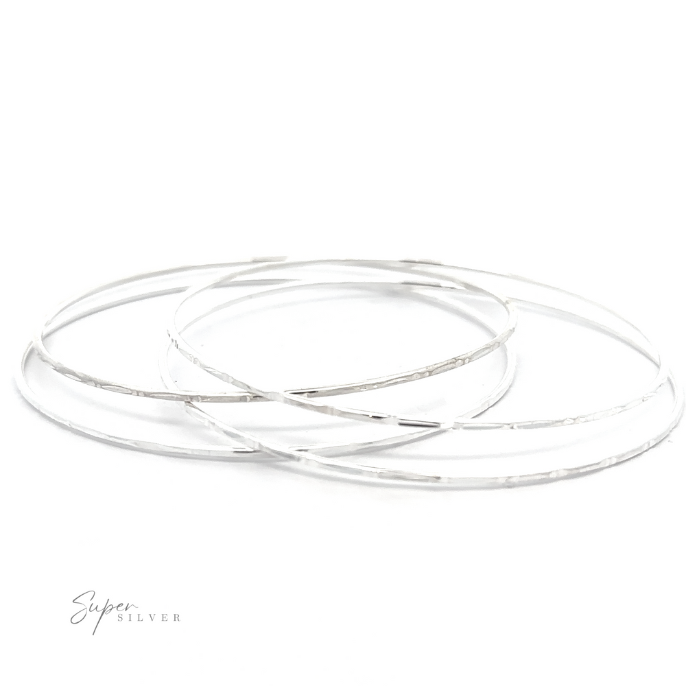 
                  
                    Three Sparkling Faceted Bangle Bracelets on a white background.
                  
                