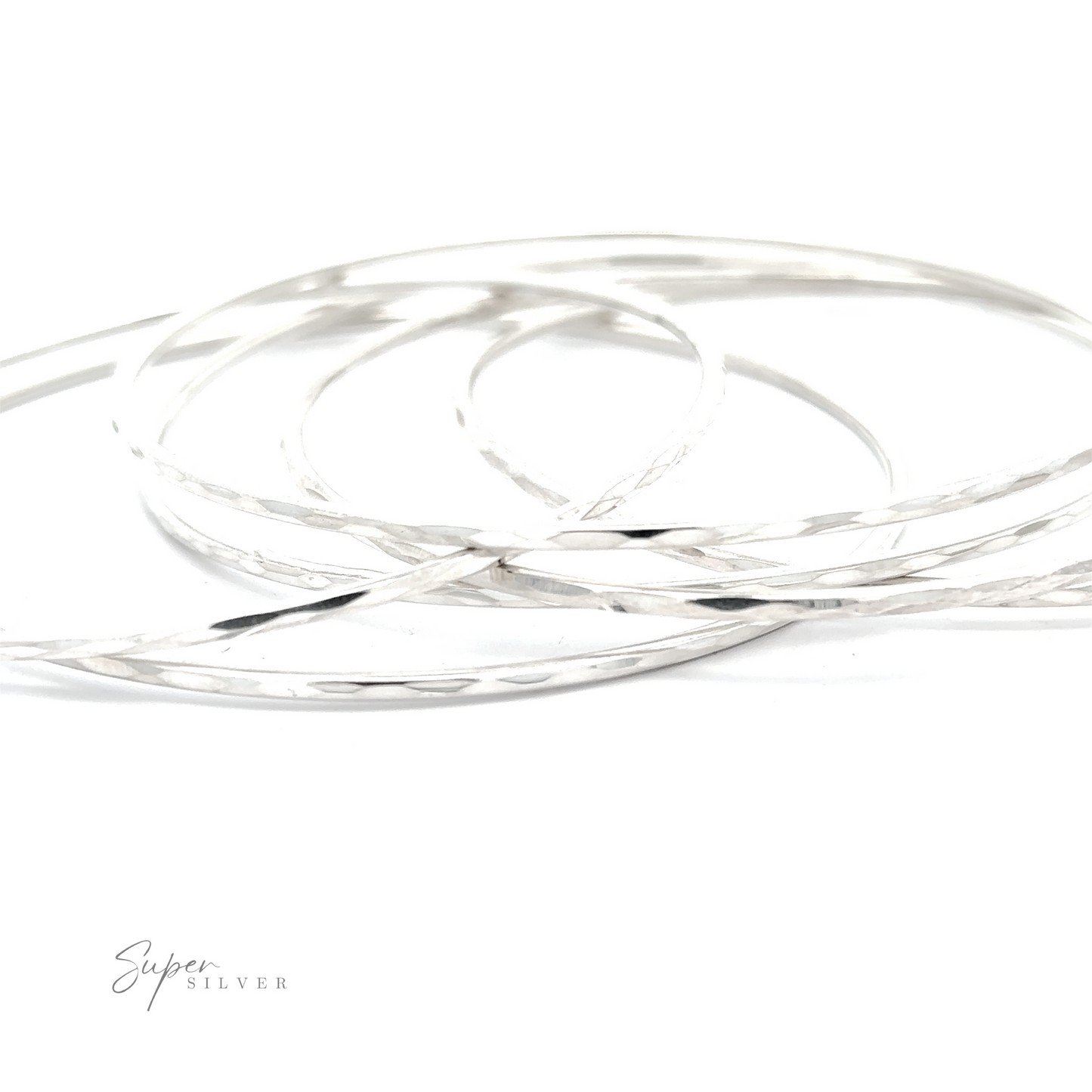 An Elegant Faceted Bangle Bracelet that sparkle on a white surface.