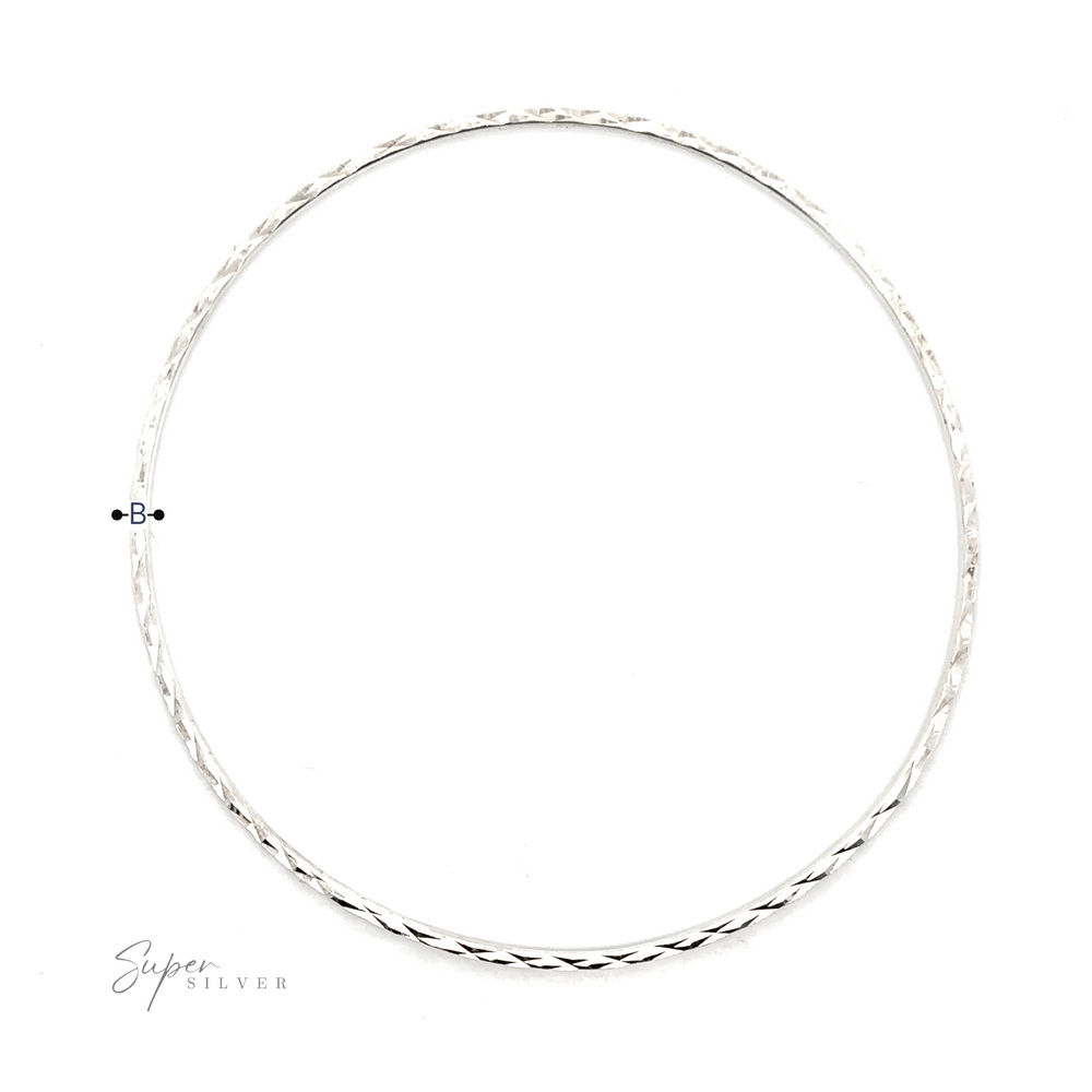 
                  
                    A elegant silver Dainty Squared Diamond Cut Bangle with a faceted diamond in the middle, adding sparkle to your look.
                  
                