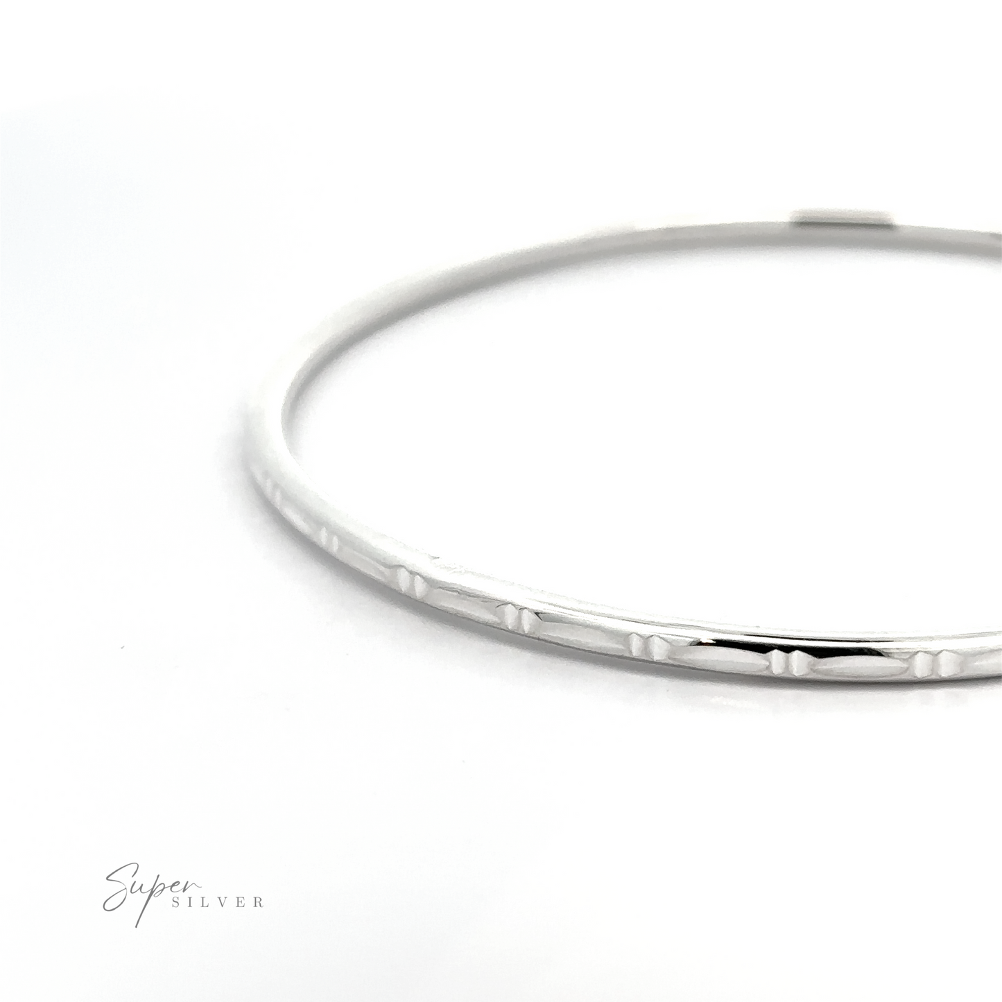 A Silver Bangle Bracelet with Faceted Cut bangle bracelet with a textured pattern and bamboo facet cut design.