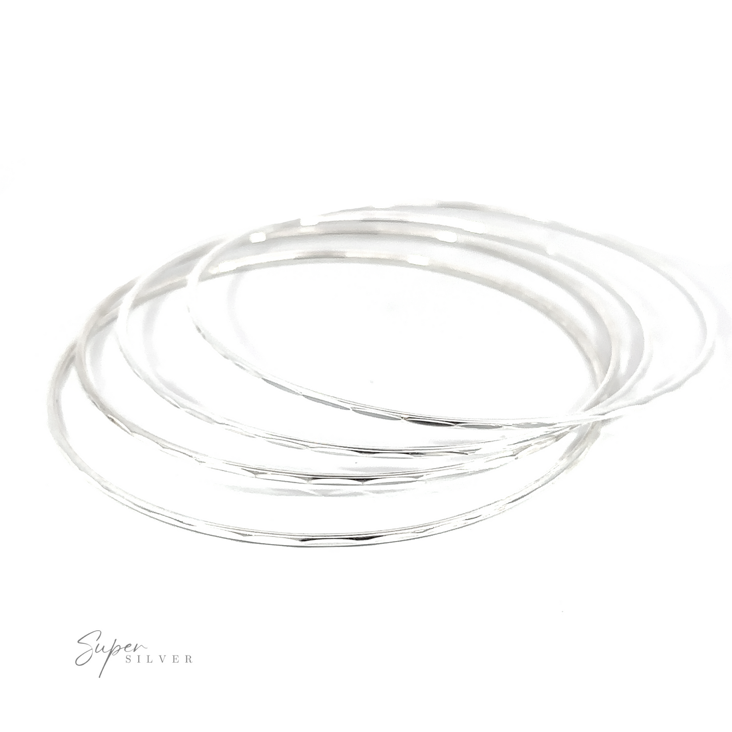 
                  
                    A stack of Dainty Faceted Silver Bangles on a white background.
                  
                
