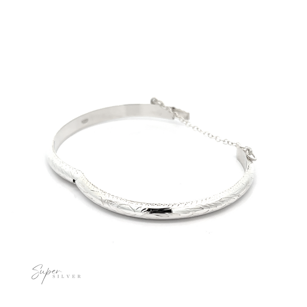 
                  
                    A Small Etched Latched Bangle adorned with a delicate chain.
                  
                