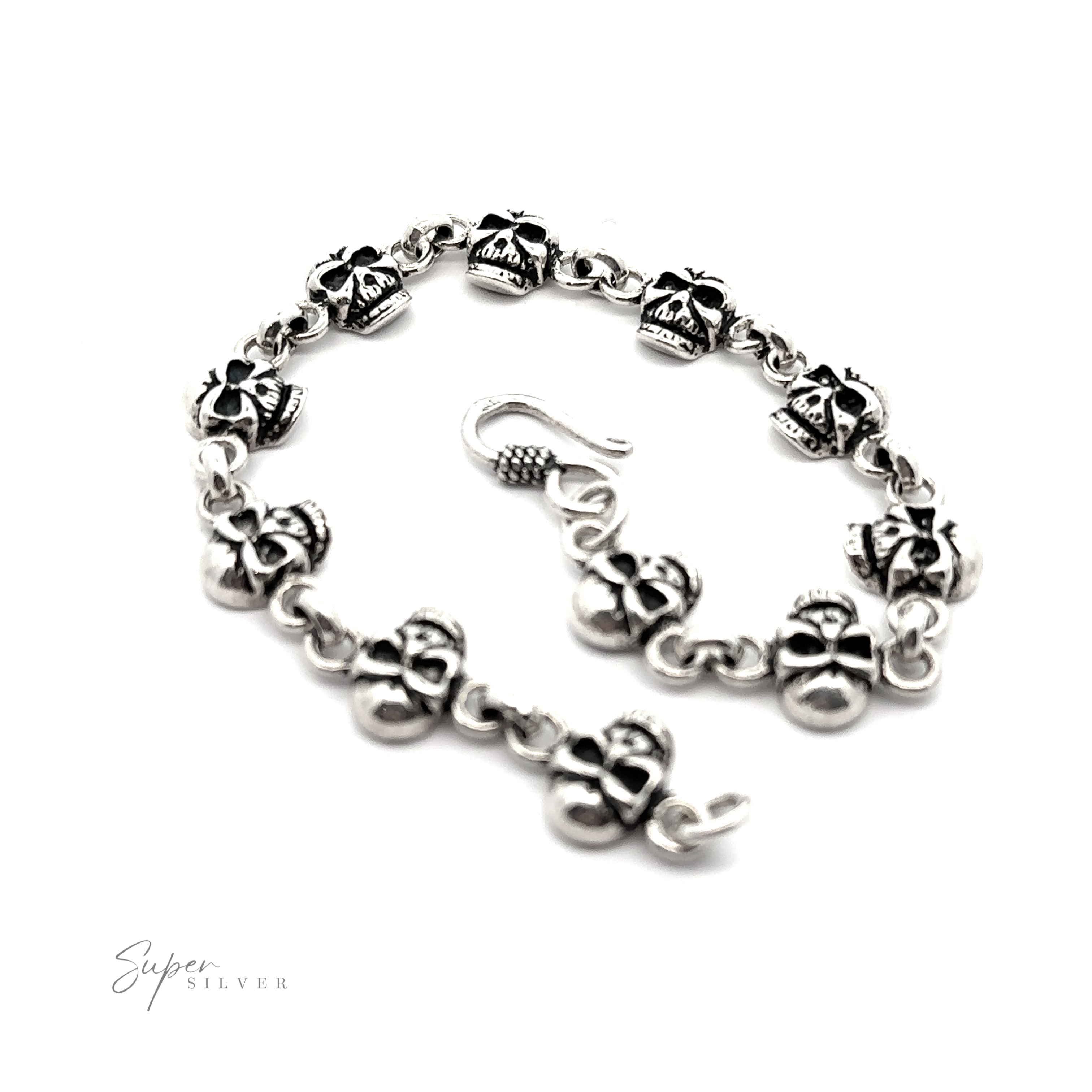 A sterling silver bracelet with a skull on it.
