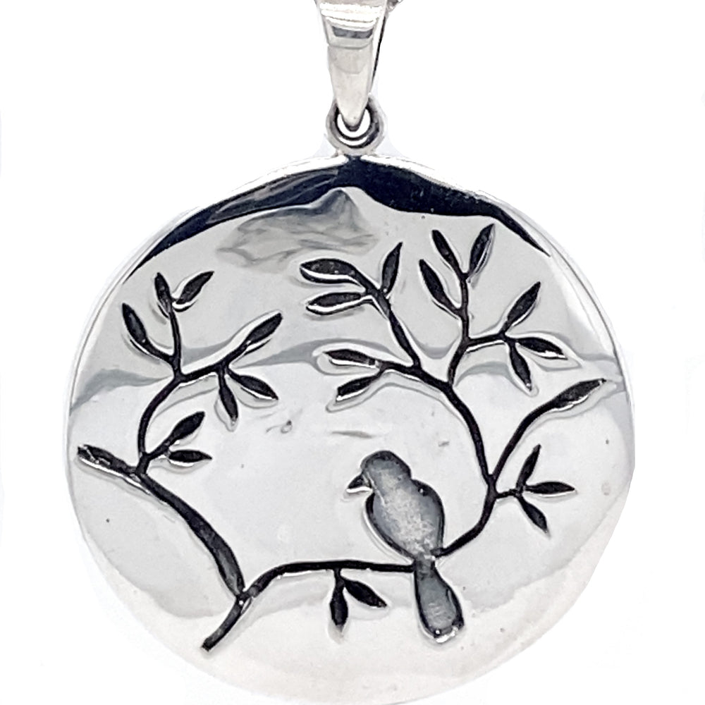 Sterling Silver Jewelry: This Large Circle Nature Pendant with Bird features an engraved bird sitting on a tree branch adorned with cherry blossoms.