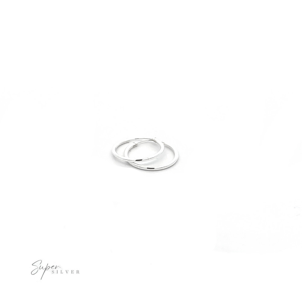 
                  
                    A pair of 1.5mm Infinity Hoops with a minimalist flair on a white background.
                  
                