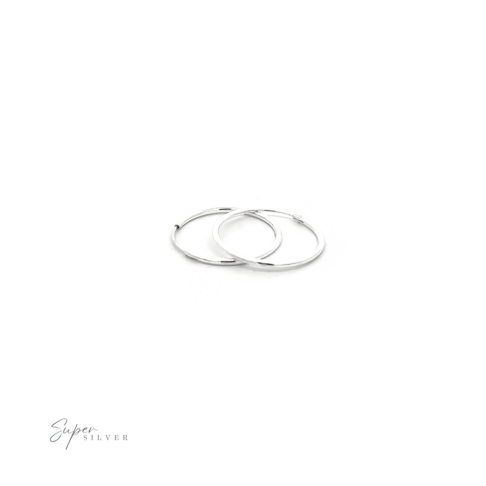 
                  
                    Two 1.5mm Infinity Hoops with minimalist flair on a white background.
                  
                