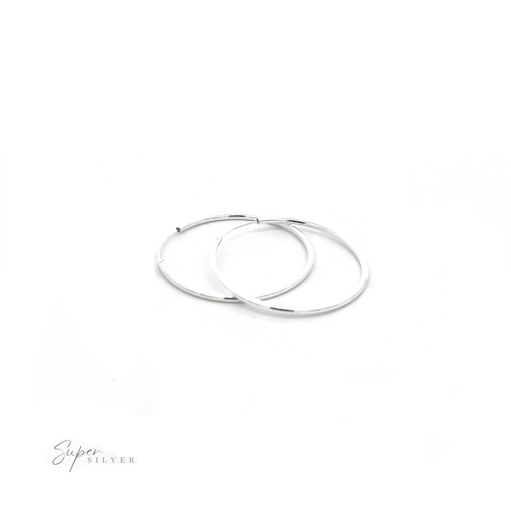 
                  
                    Versatile 1.5mm Infinity Hoop earrings with a minimalist flair, displayed on a white background.
                  
                