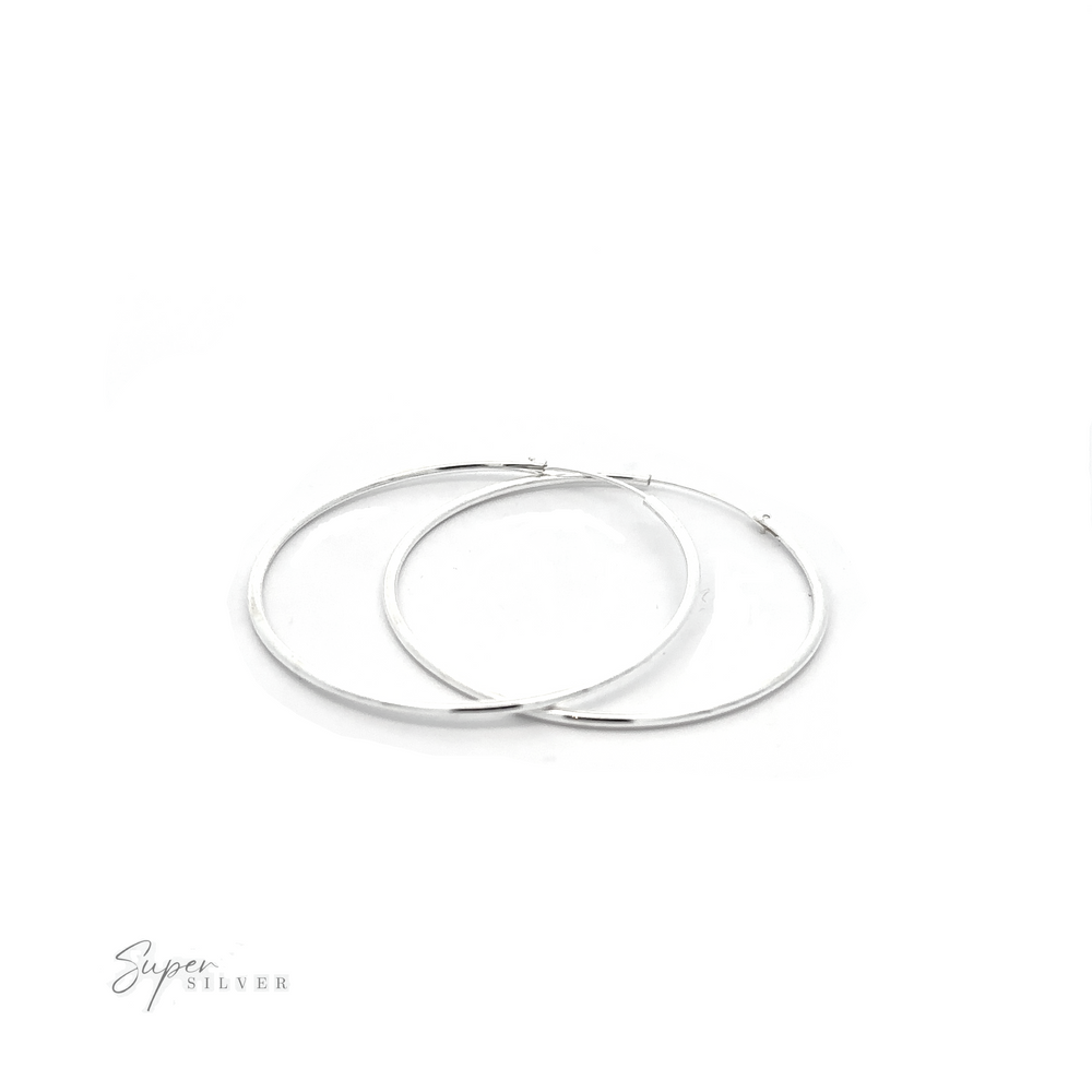 
                  
                    A pair of versatile 1.5mm Infinity Hoops with a minimalist flair on a white background.
                  
                
