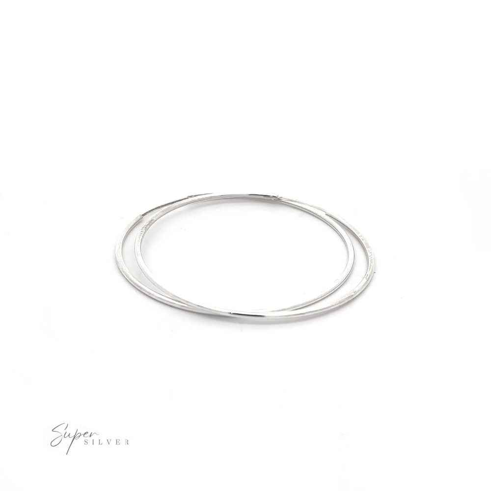 
                  
                    A pair of versatile 1.5mm Infinity Hoops with a minimalist flair on a white background.
                  
                