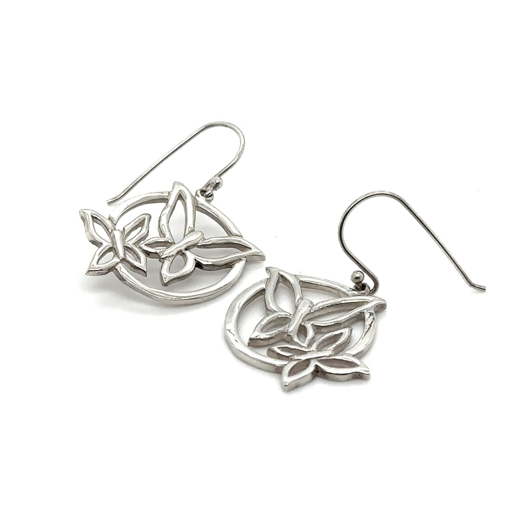 
                  
                    A pair of Super Silver Butterfly Outline Earrings with leaves on them, featuring french hook clasps.
                  
                