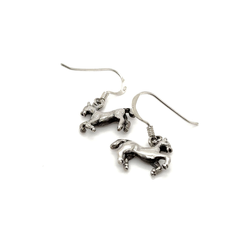 A pair of Super Silver horse earrings on a white background.