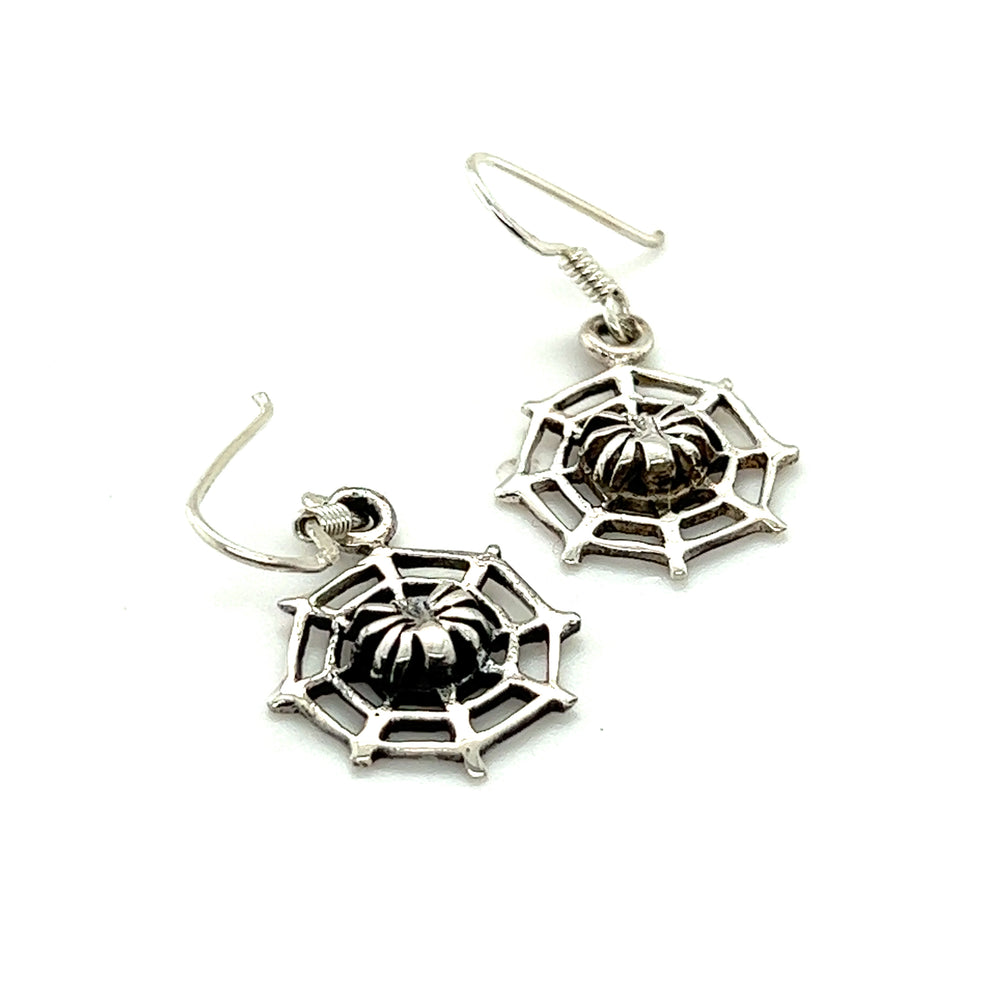 A pair of Super Silver Spider in Web Earrings on a white background, perfect for witches and fans of the occult.