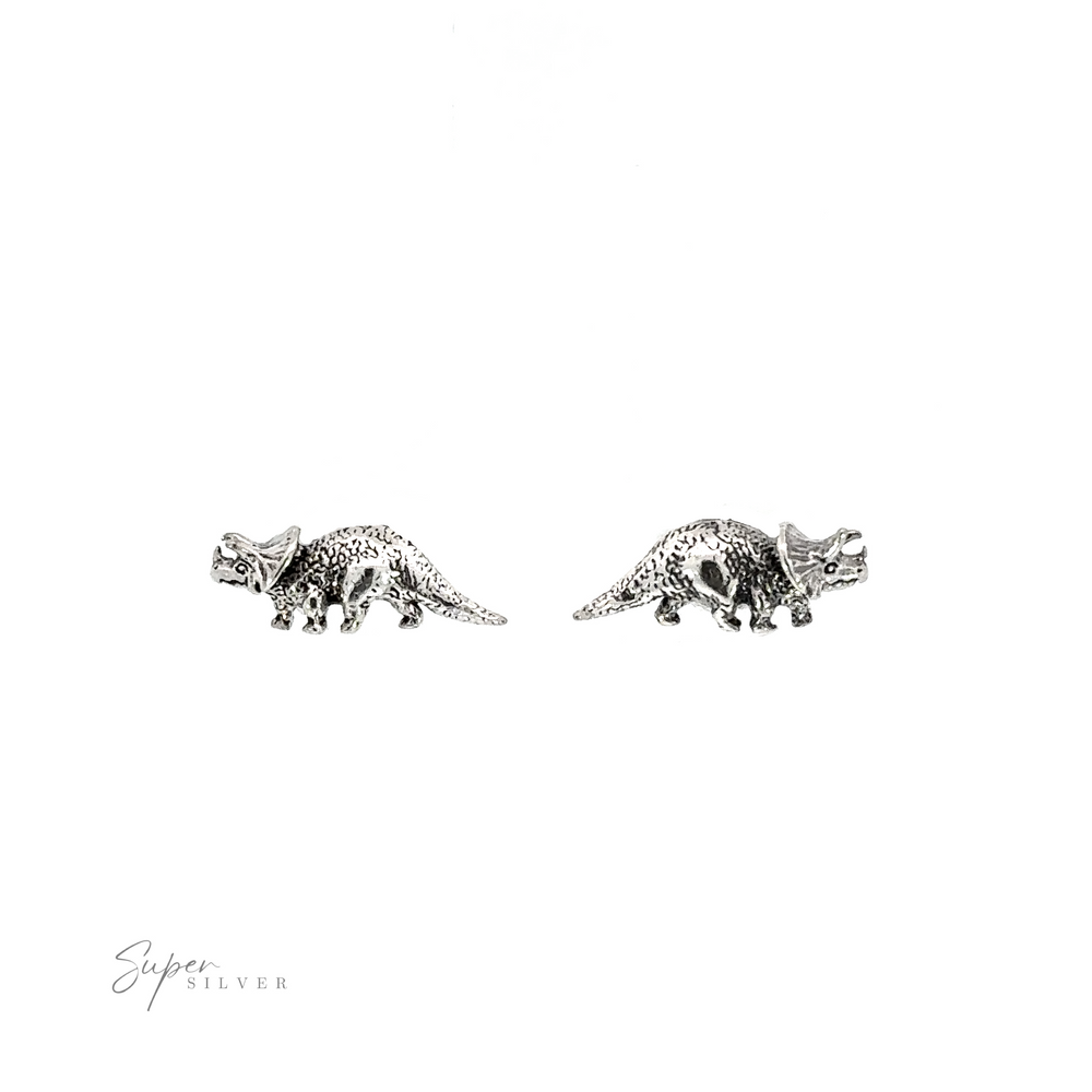 A pair of silver Triceratops Studs, the perfect prehistoric addition for any occasion, showcased on a white background.