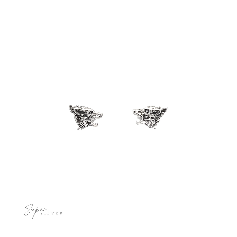 
                  
                    A pair of Wolf Head Studs on a white background.
                  
                