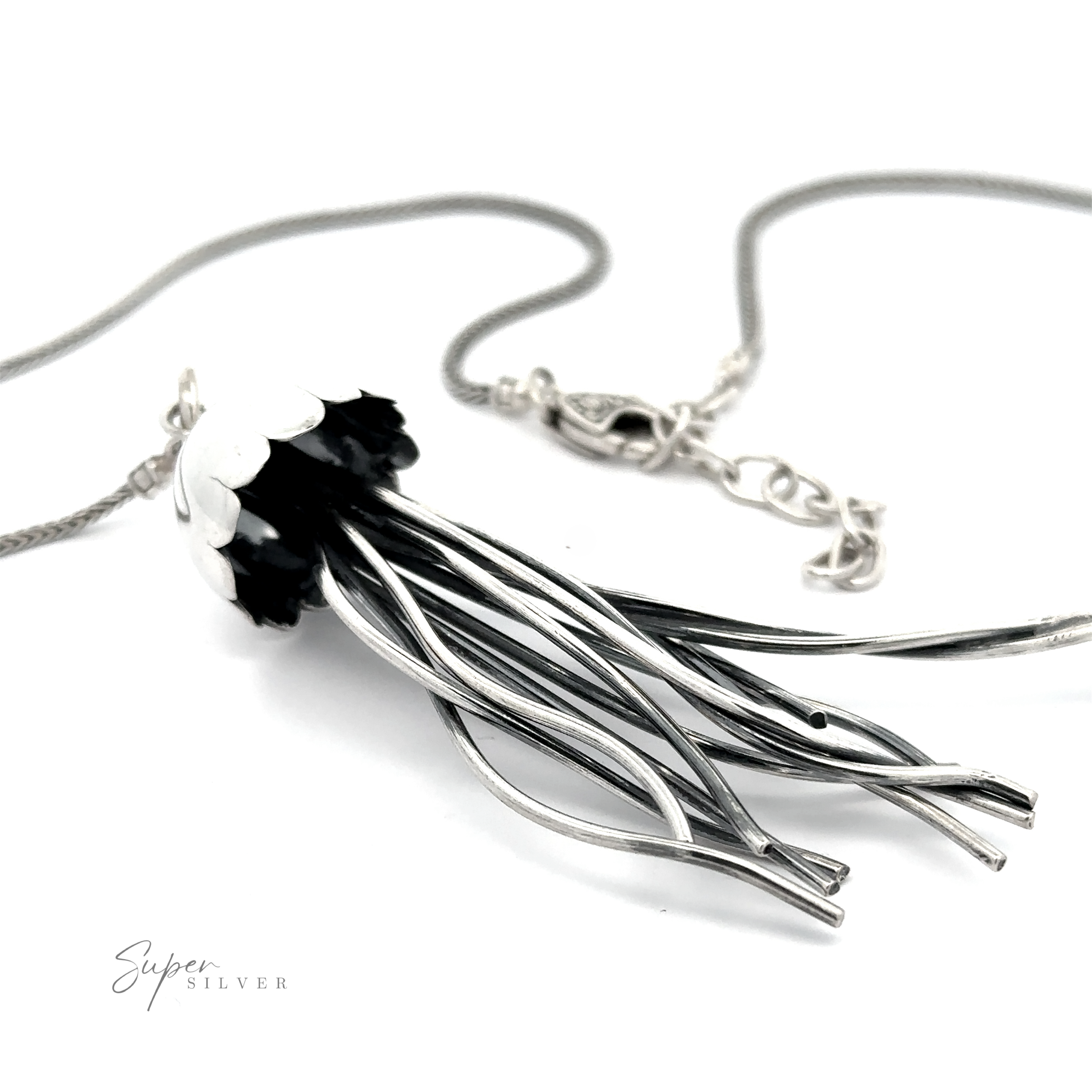 Jellyfish Necklace resembling a stylized bouquet of flowers with black and white petals, displayed on a white background with a sterling silver chain.