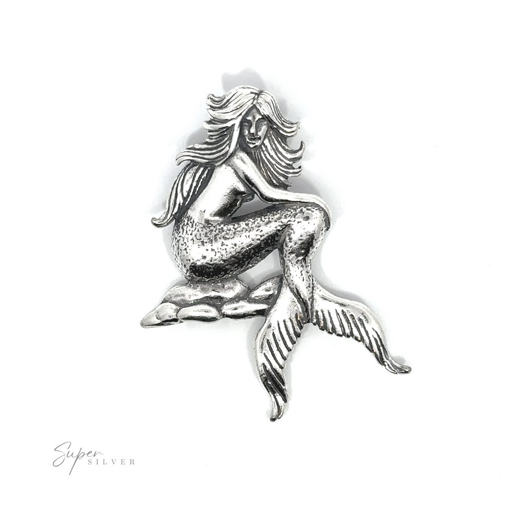 A captivating Seductive Mermaid Pendant featuring a stunning silver mermaid, gracefully perched on a rocky surface.