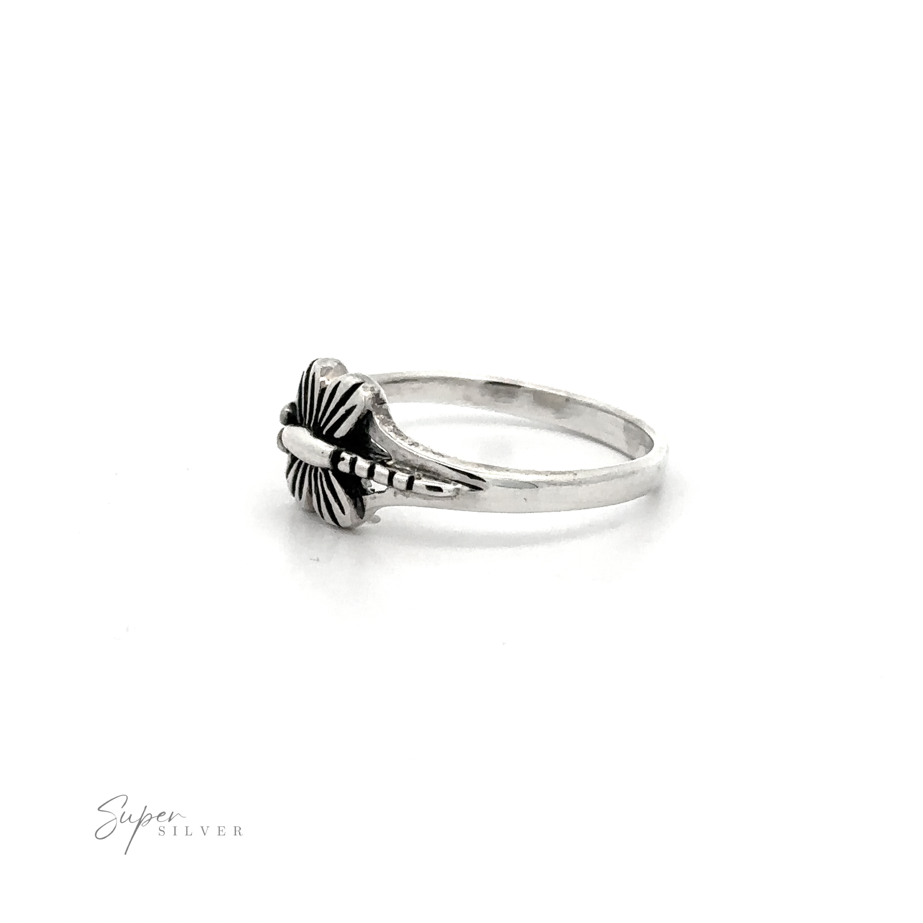 A delicate small dragonfly ring with a cross on it.