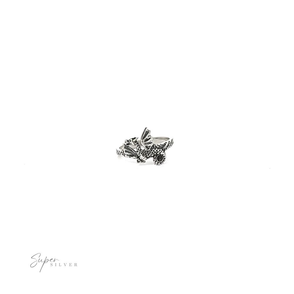 
                  
                    A small silver Dragon Ring with a bird on it featuring scale detail.
                  
                