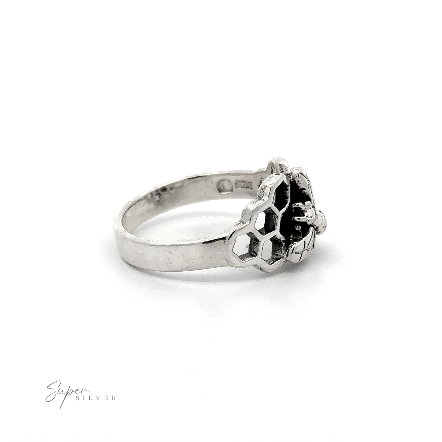 A Honey Bee with Honeycomb ring with black and white stones.