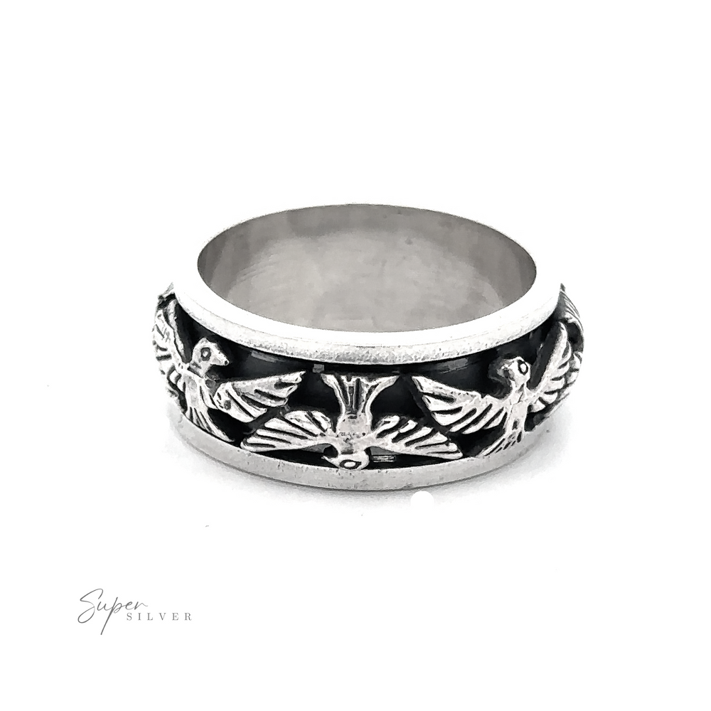 
                  
                    The Thick Thunderbird Spinner Ring featuring a design of three detailed thunderbirds in flight engraved around the band. The slightly oxidized band highlights the bird motifs, with one bird centrally positioned and two symmetrically on either side.
                  
                