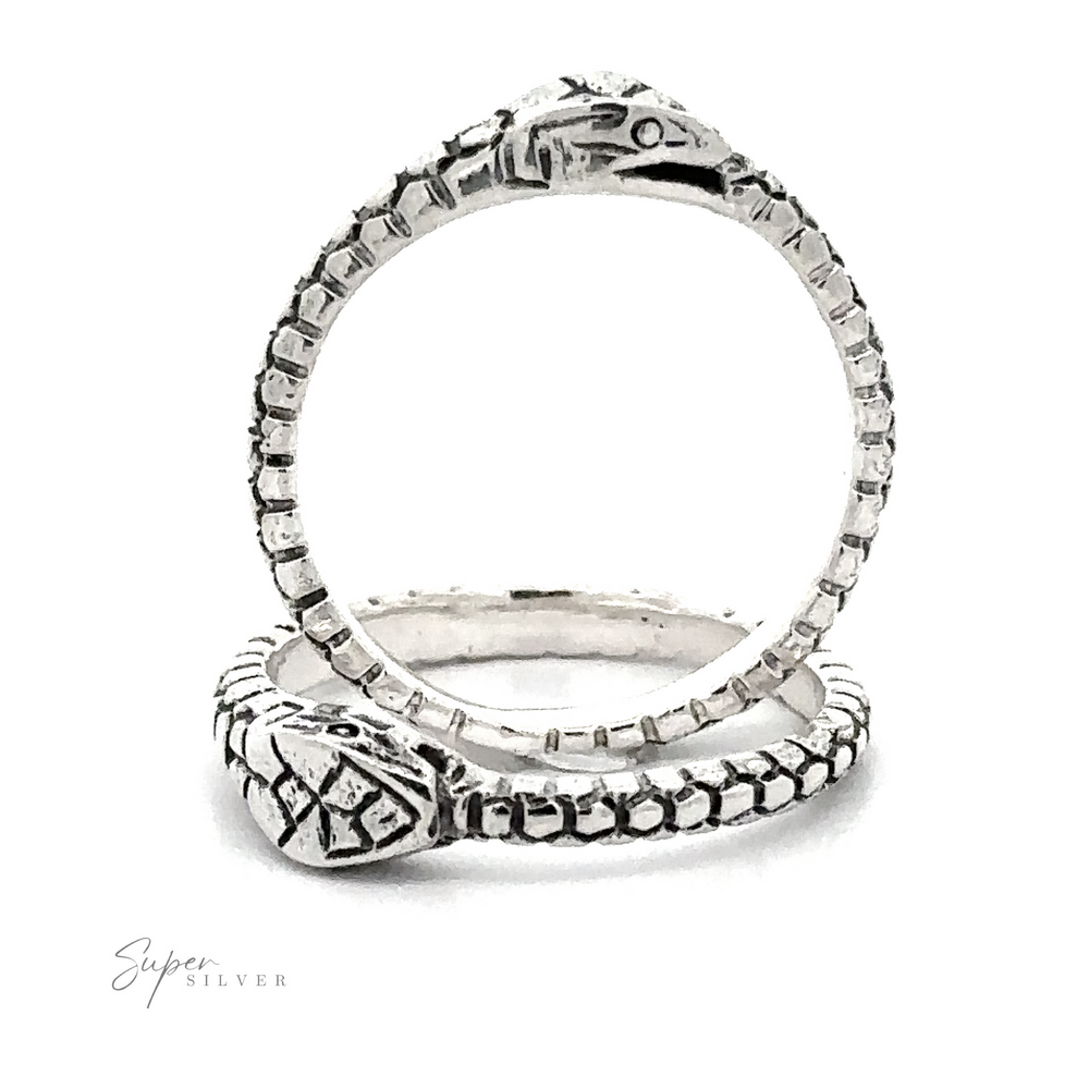 A Ouroboros Ring featuring intricate tribal patterns along the band, displayed on a white background with a visible logo reading 