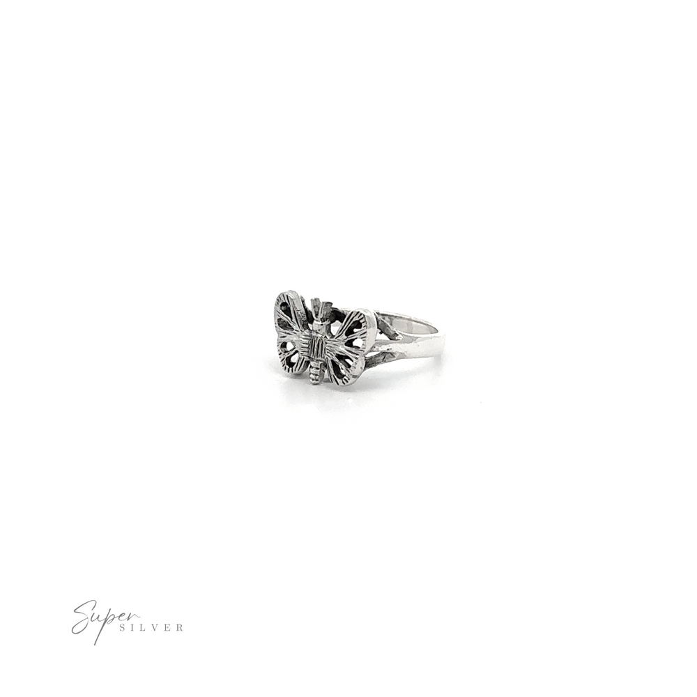 
                  
                    A Silver Butterfly Ring with a small flower on a thick band.
                  
                