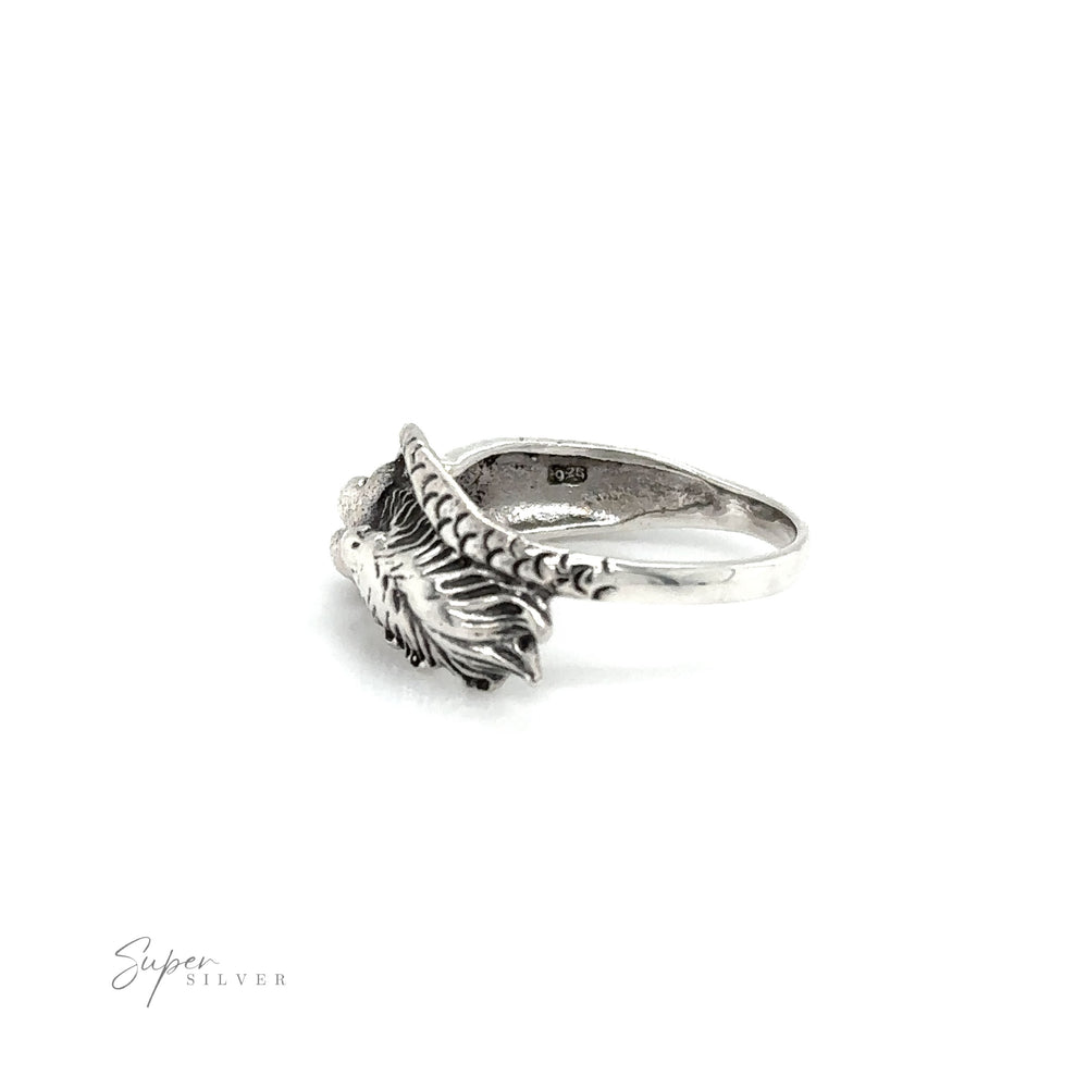 
                  
                    A Mermaid Ring with Swirly Tail with an oceanic feather on it.
                  
                