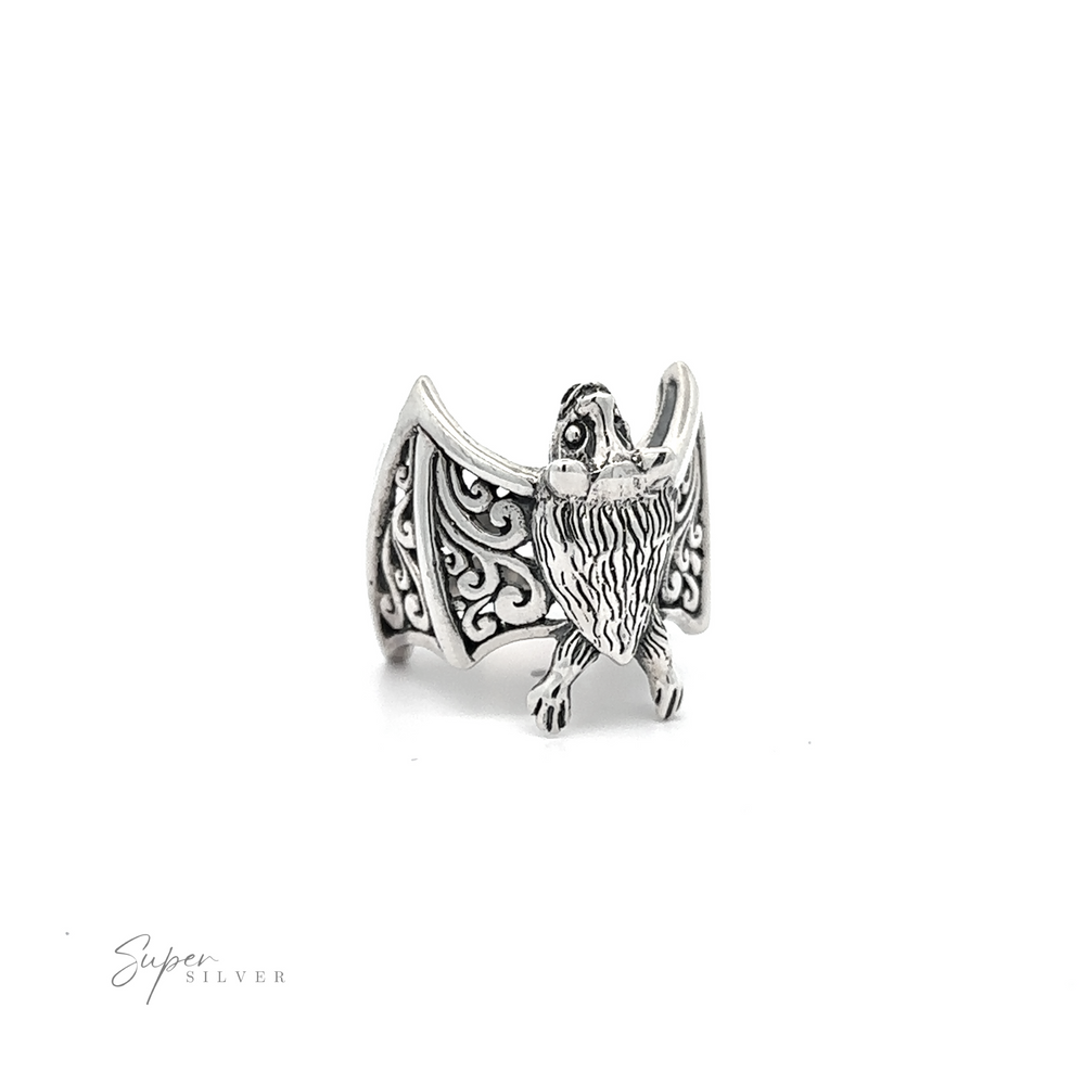 
                  
                    A Statement Bat Ring shaped like a stylized bat with spread wings, featuring intricate engravings, on a white background.
                  
                