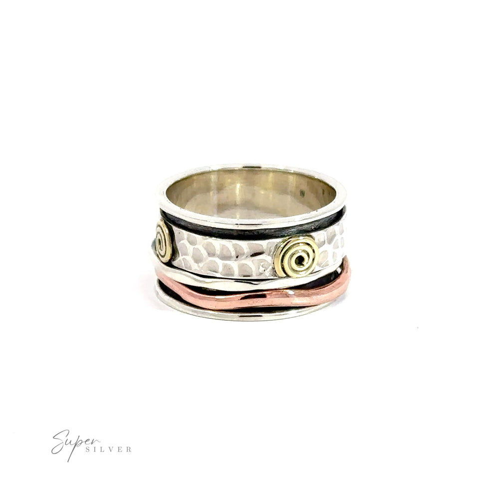 A Handmade Spinner Ring with Copper and Gold Spirals featuring a hammered silver band and rose gold spiral accents.
