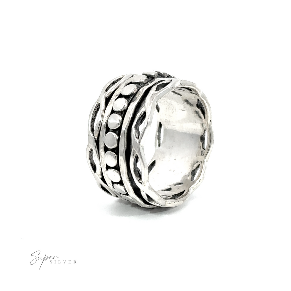 A Spinner Ring with Twisted Borders, adorned with dots, in a stunning silver design.