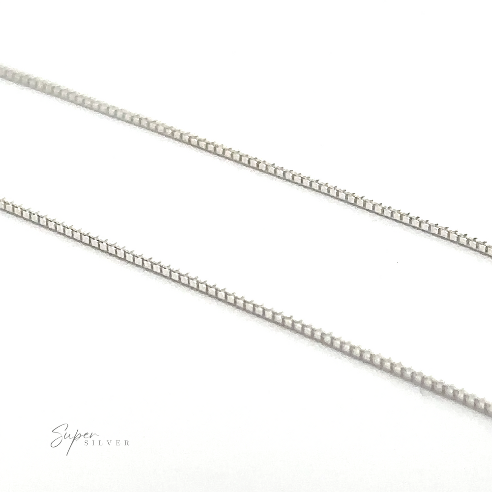 
                  
                    Two delicate, Italian-made sterling silver box chains are displayed diagonally on a white background with the text "Super Silver" in one corner.
                  
                