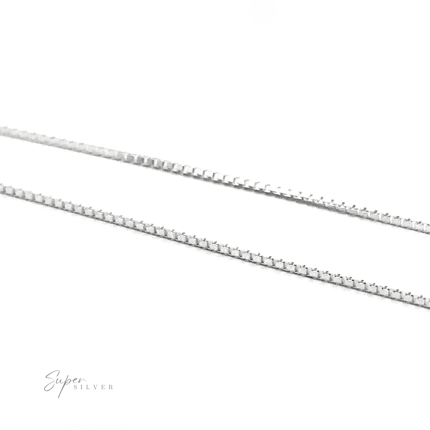 
                  
                    Close-up of two thin silver chains lying parallel to each other on a white surface. The chains feature a textured, interlocking design, ideal for layering necklaces. The text "Super Silver" is visible at the bottom left corner, highlighting the elegant Adjustable Silver Box Chain crafted from Sterling silver with an adjustable length.
                  
                