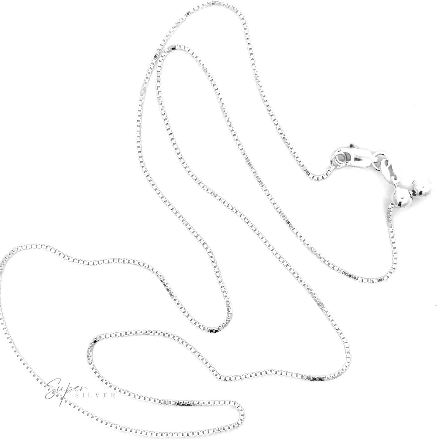 An Adjustable Silver Box Chain necklace, featuring a sterling silver clasp and two small attached balls, lies against a white background. The adjustable length allows for effortless layering of necklaces. The "Super Silver" logo is visible in the bottom left corner.