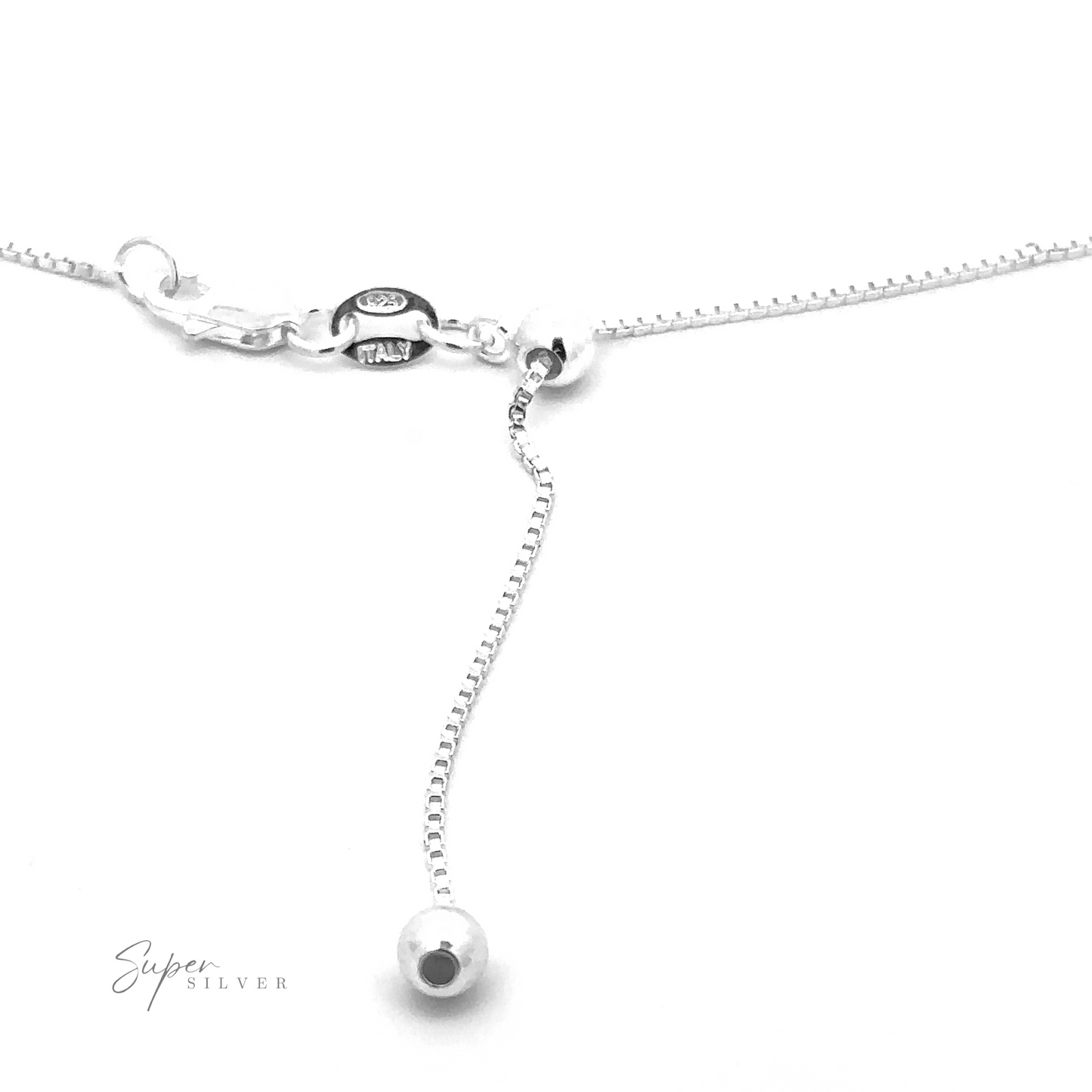 
                  
                    Close-up of the Adjustable Silver Box Chain necklace showcasing its delicate clasp mechanism. The adjustable length ensures perfect layering with other necklaces. It features a sliding bead and a small circular pendant at the end.
                  
                