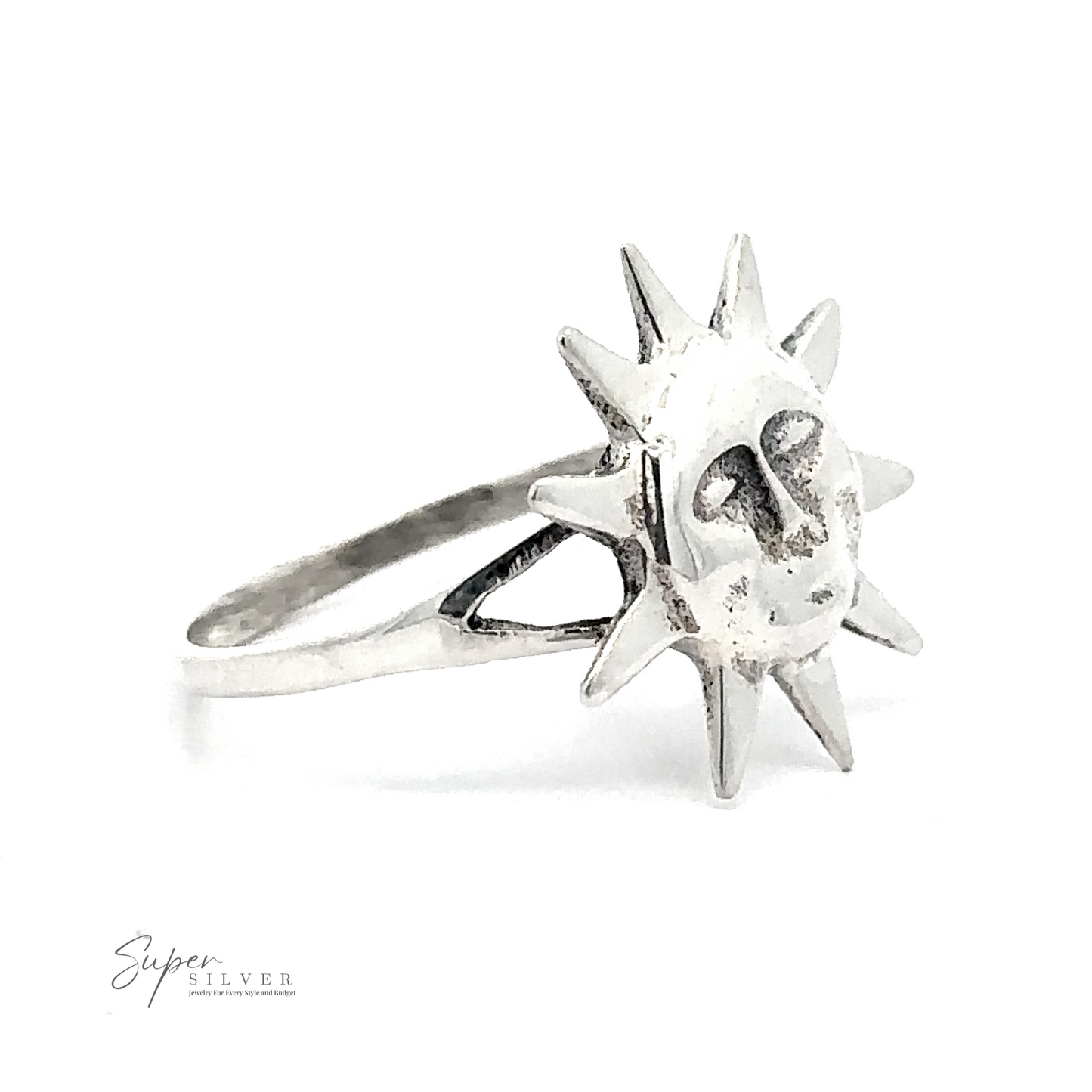 The Silver Sun Ring is a sterling silver ring adorned with a sun design that has a face on the front. The words "Super Silver" are printed in small font at the bottom left of the image.