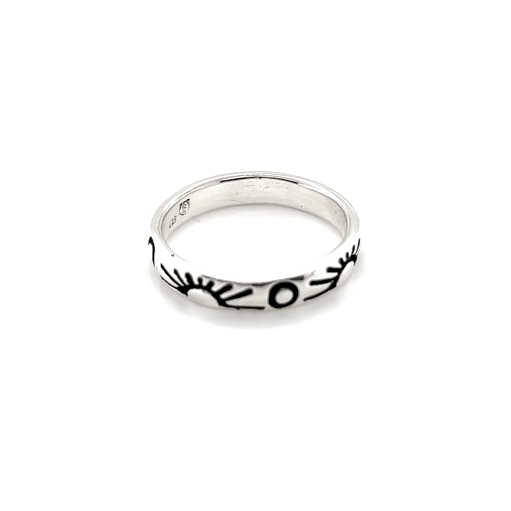 A Sun and Moon Etched Band Ring with black and white designs depicting a perfect balance of the sun and moon.