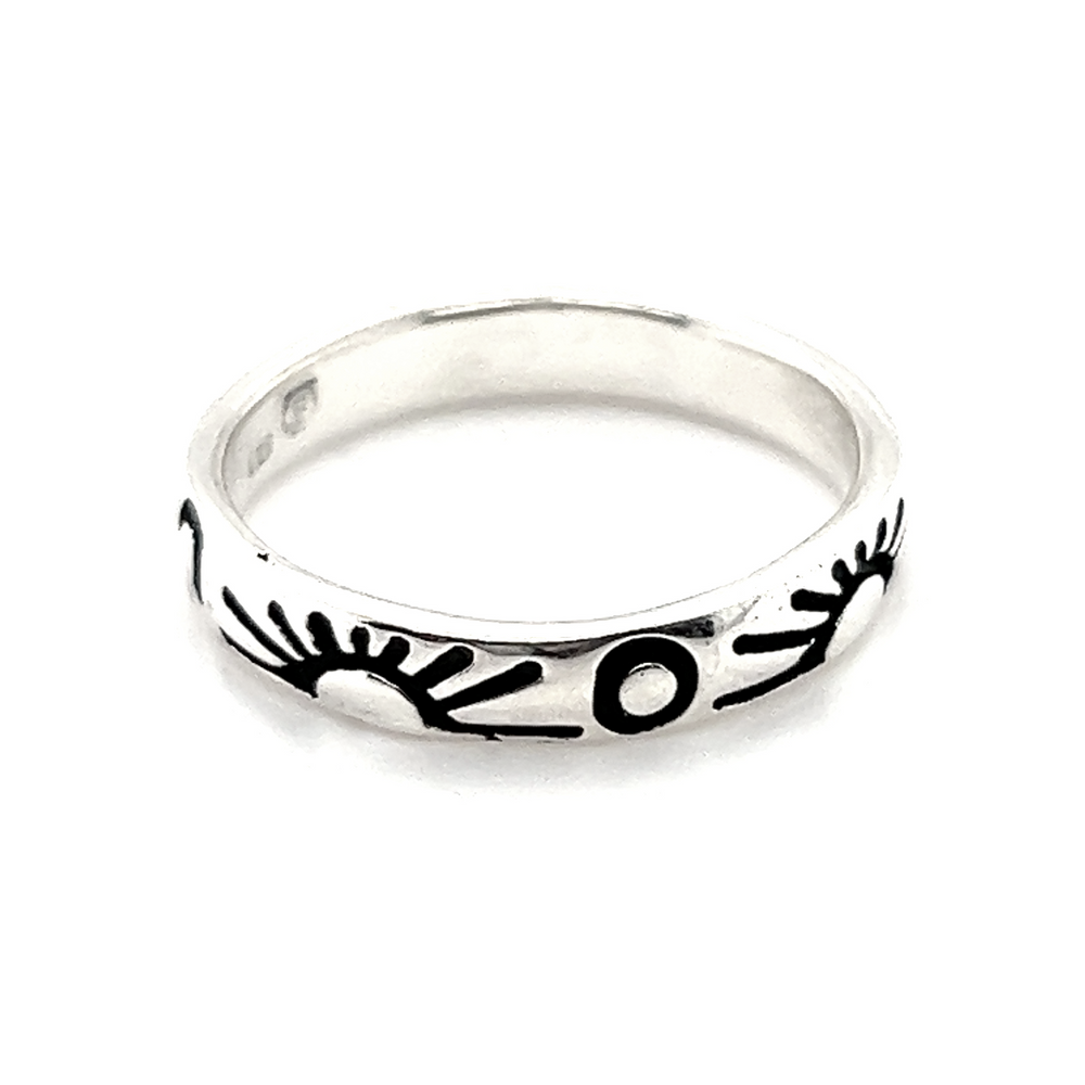 A Sun and Moon Etched Band Ring with black and white designs representing balance in life.