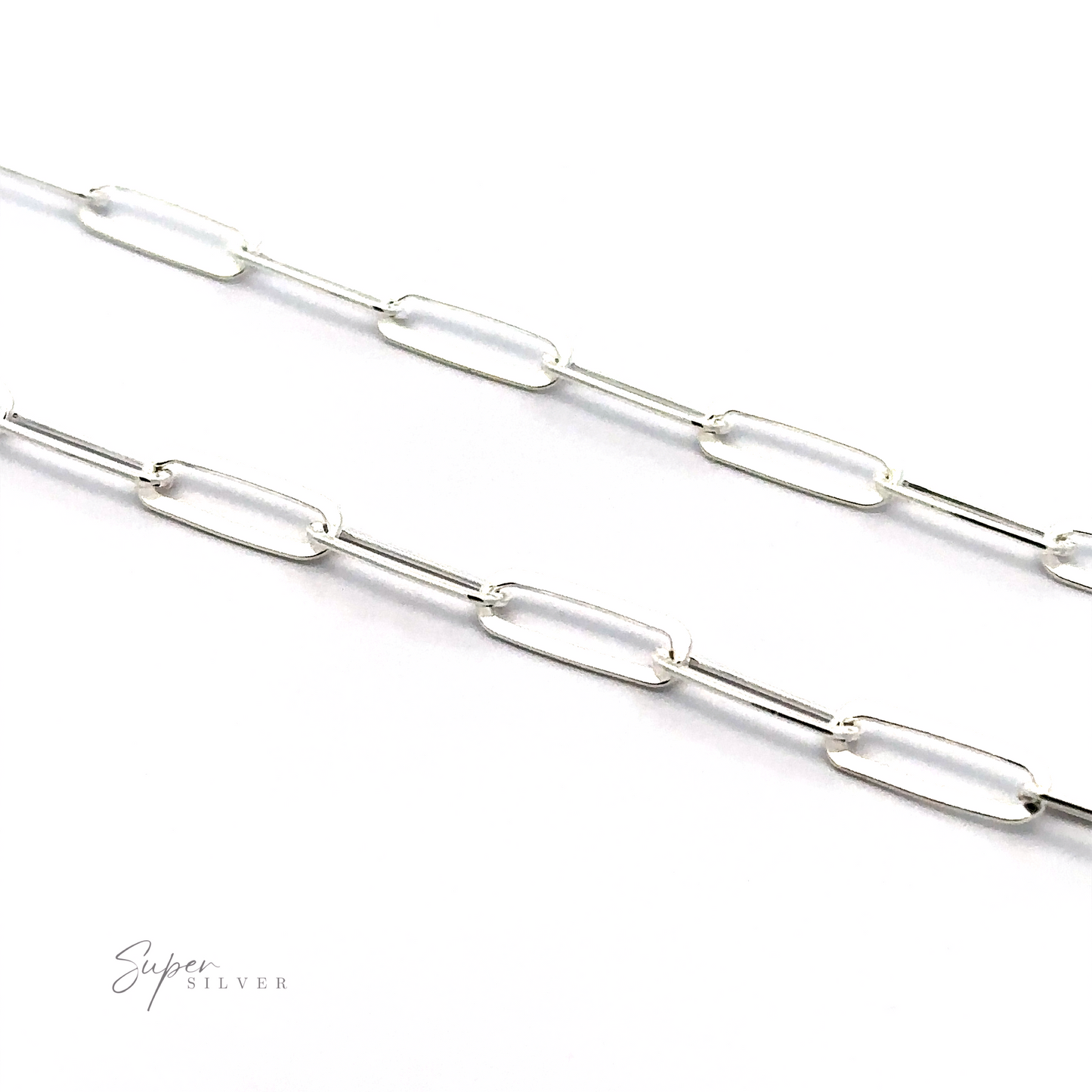 
                  
                    A close-up view of a Sterling Silver Paperclip Chain with elongated oval links on a white background. The minimalist design highlights expert Italian craftsmanship, while the Super Silver logo is visible in the bottom left corner.
                  
                