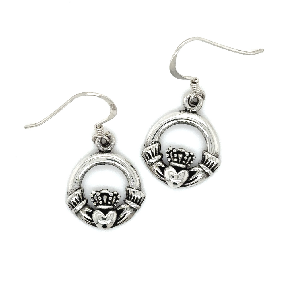 A pair of Super Silver Claddagh earrings on a white background.