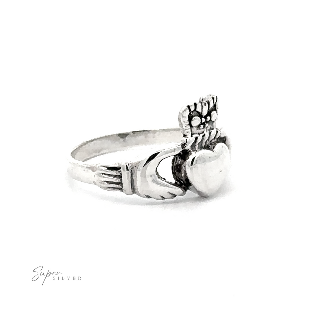
                  
                    Silver Claddagh Ring featuring a floral design and a prominent round gemstone, displayed against a white background with "super silver" logo.
                  
                