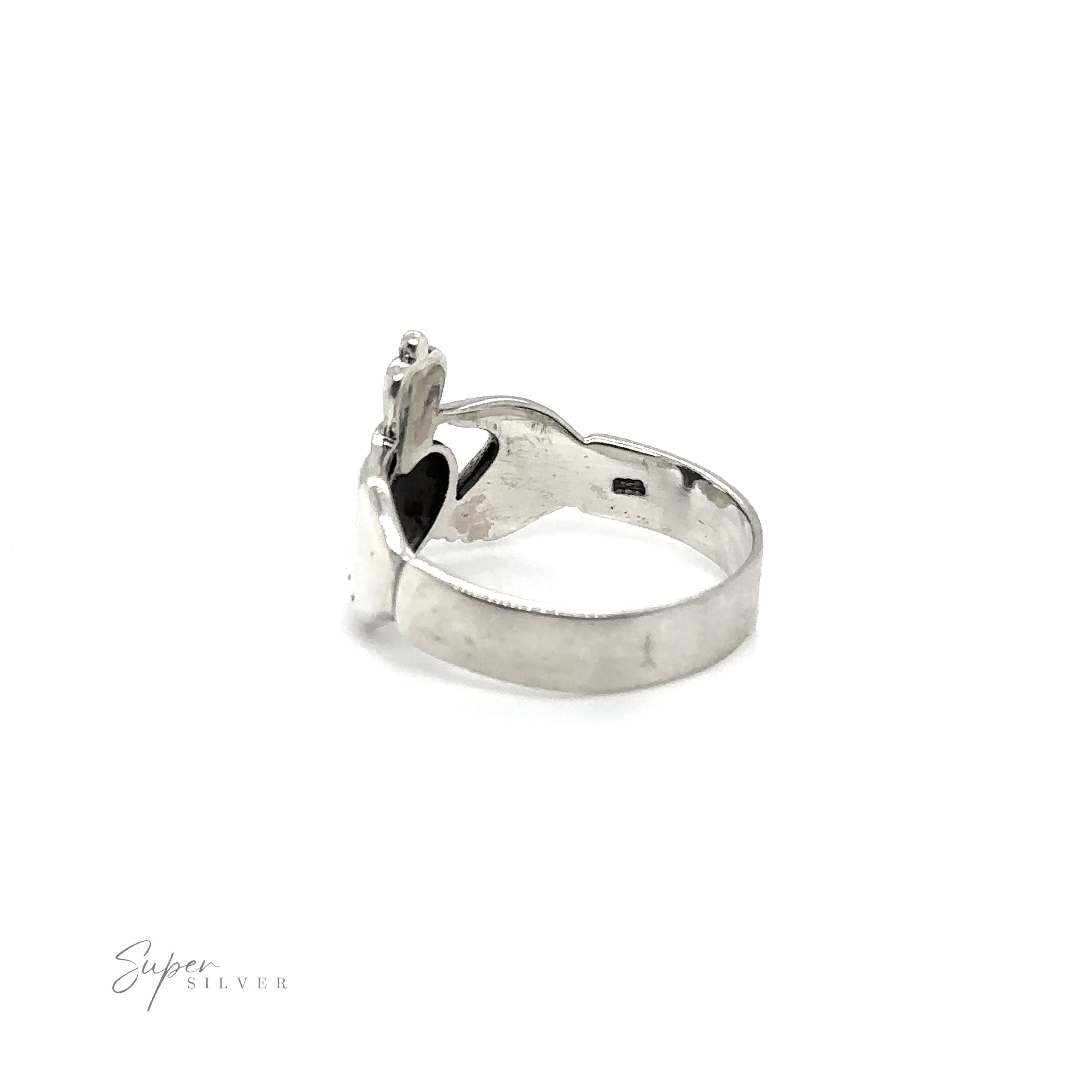 A Thick Claddagh ring, symbolizing love and loyalty, featuring a silver band and a black stone at its center.