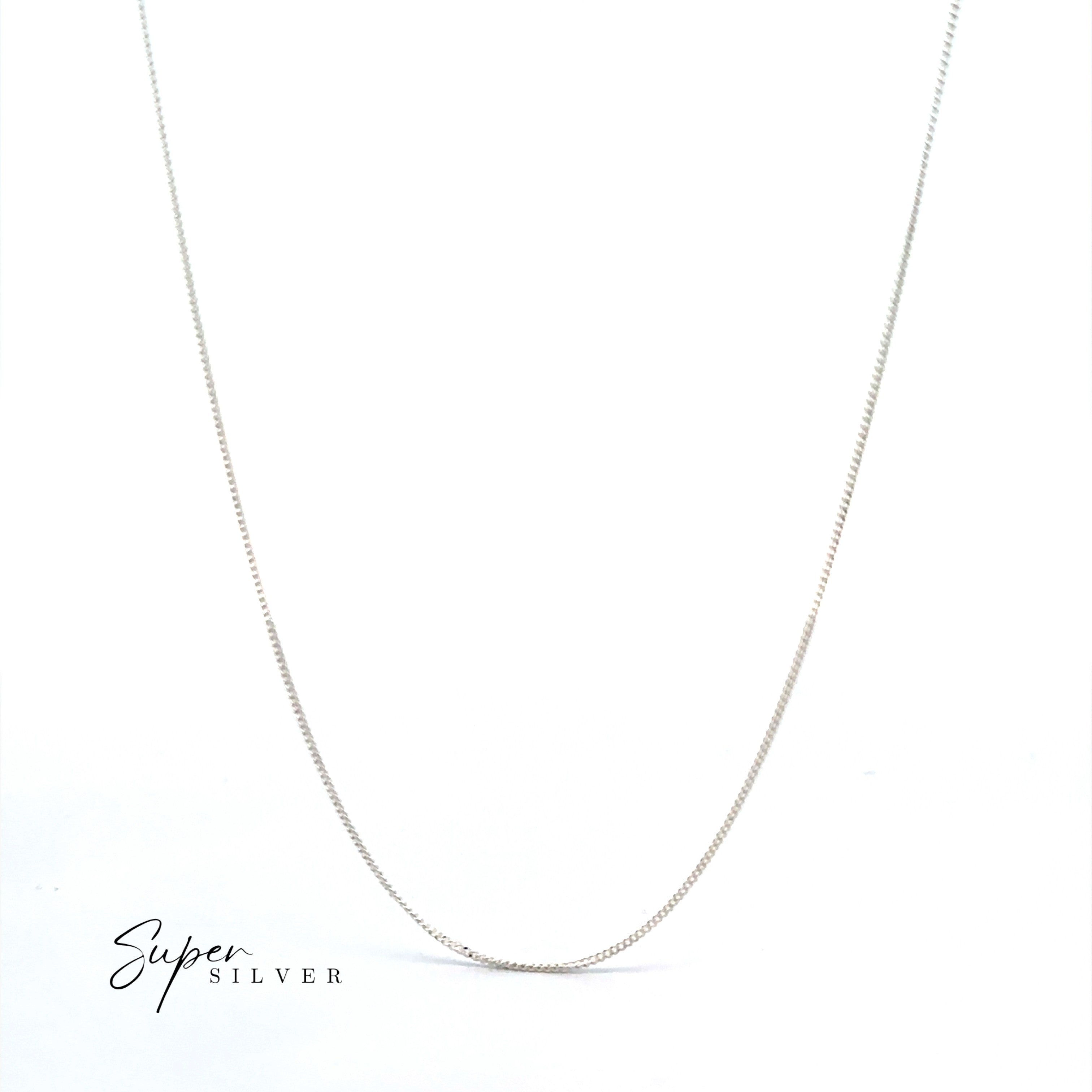 The Dainty Italian Curb Chain, crafted from sterling silver, is shown on a white background with "Super Silver" in the lower left—perfect for layering.