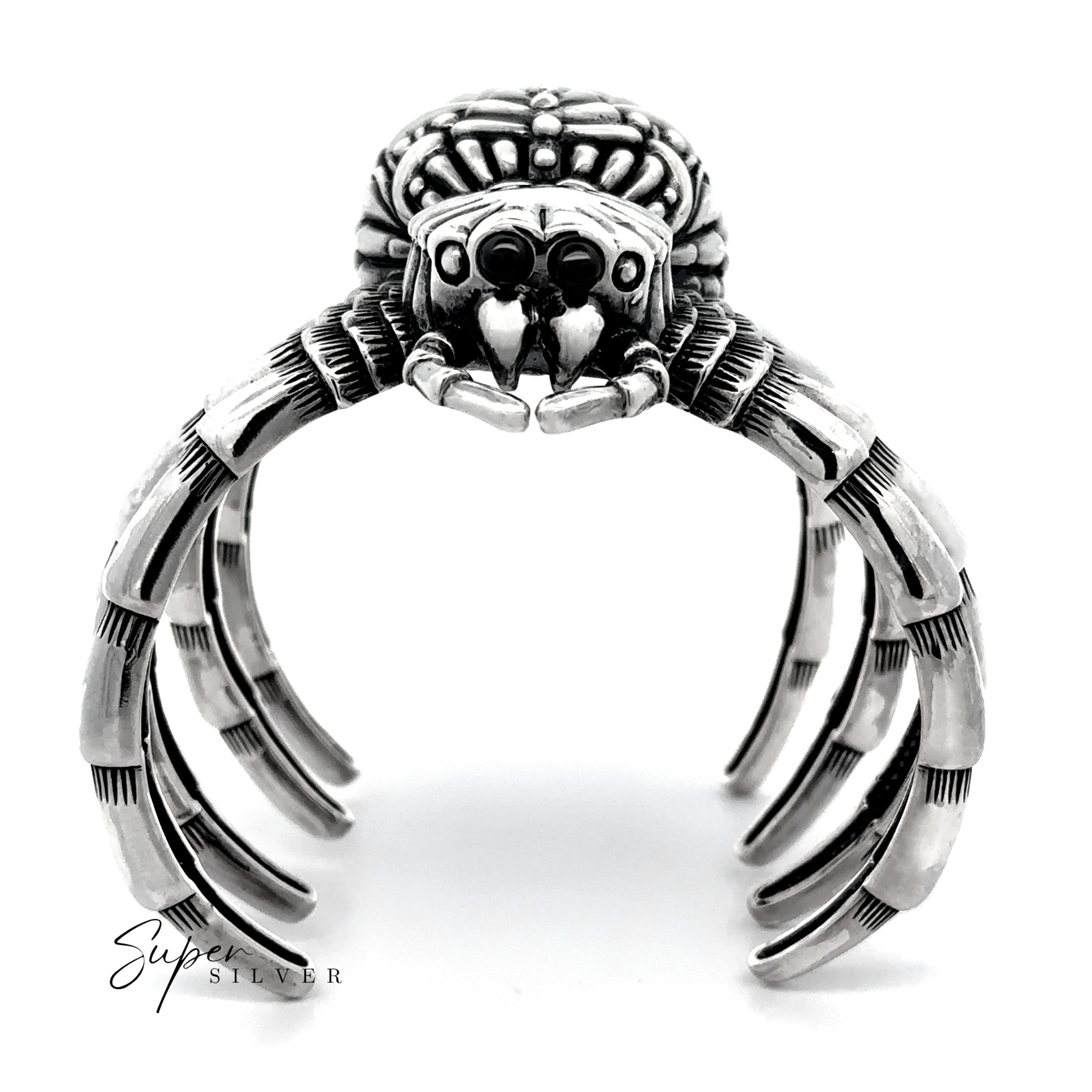 The Witch Weaver Spider Cuff is a sterling silver jewelry bracelet featuring detailed legs and facial features, creating a unique statement piece shown on a white background.