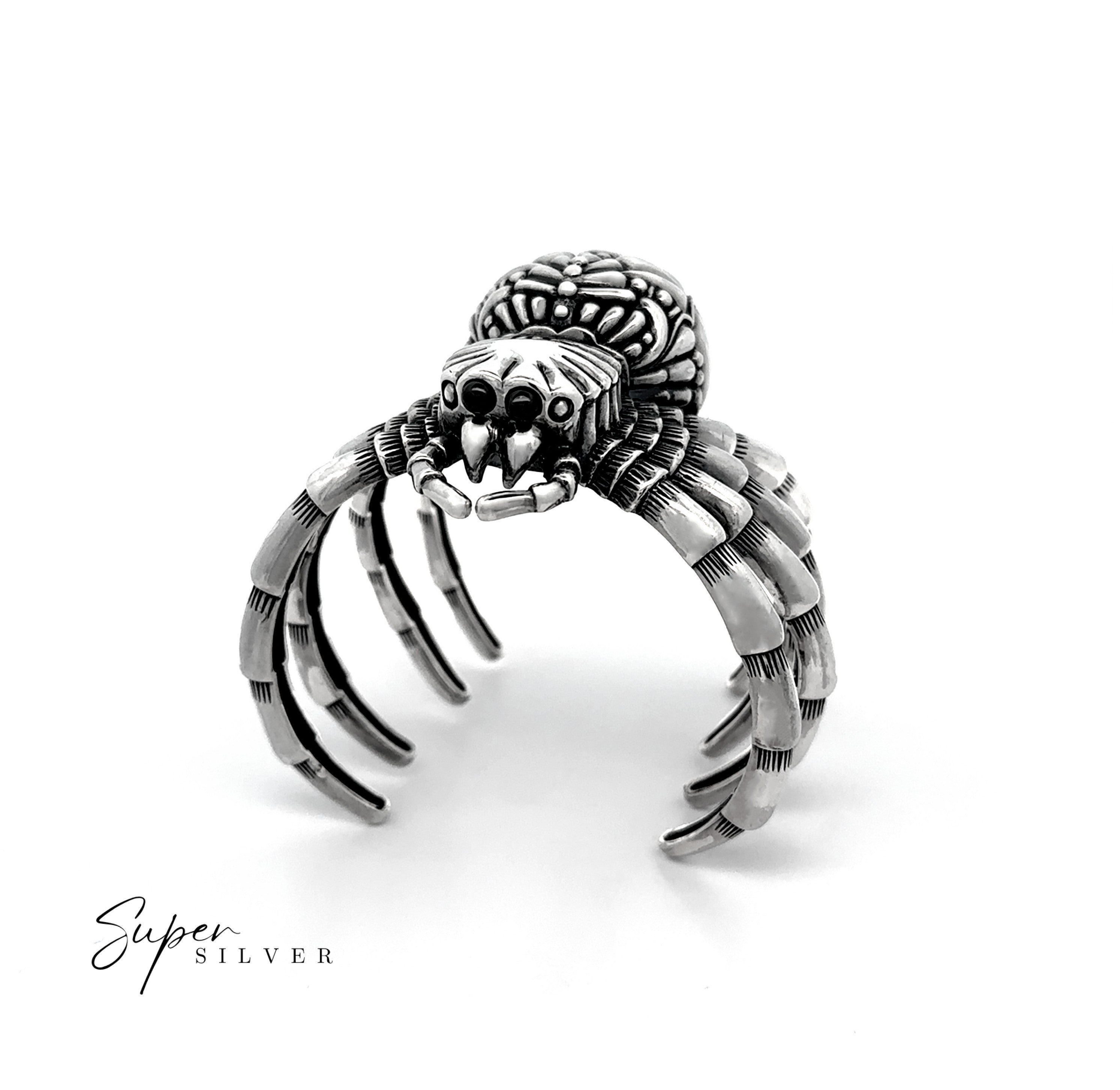 The Witch Weaver Spider Cuff is a silver ring crafted to look like a spider, featuring intricate legs and body details. Photographed on white with "Super Silver" text in the corner, it's a standout for sterling silver jewelry fans.