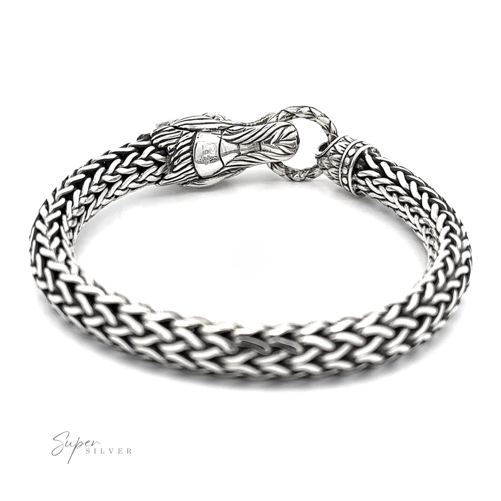 
                  
                    A Sterling Silver Braided Rope Bracelet with Dragon Head featuring a clasp designed to resemble a dragon's head biting a ring, this bold statement piece is sure to capture attention.
                  
                
