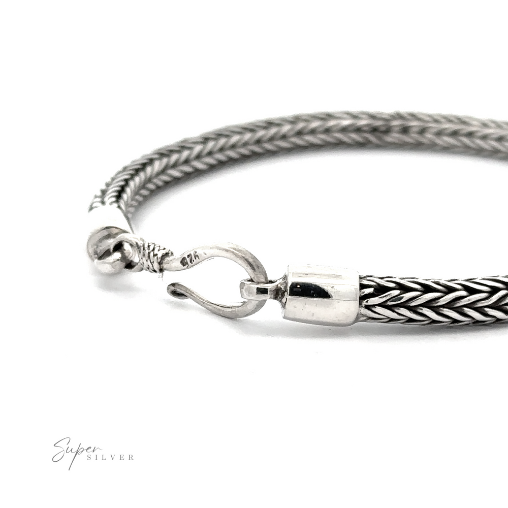 A close-up image of a sterling silver chain bracelet with a hook clasp, labeled "4mm Braided Bracelet" in the corner, ideal for everyday wear.