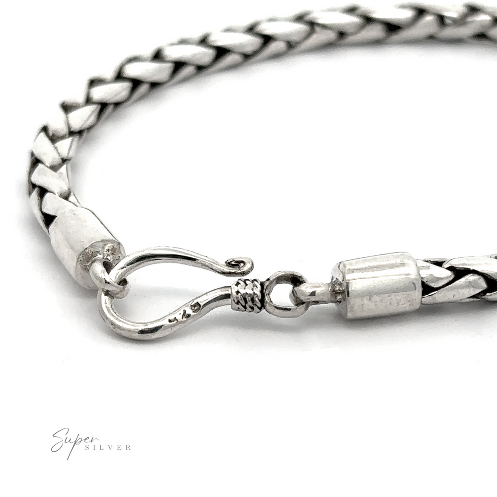 
                  
                    Close-up of a 4mm Bright Rope Bracelet made from silver braided ropes, featuring a hook clasp. The text ".925 Sterling Silver" appears in the lower left corner.
                  
                