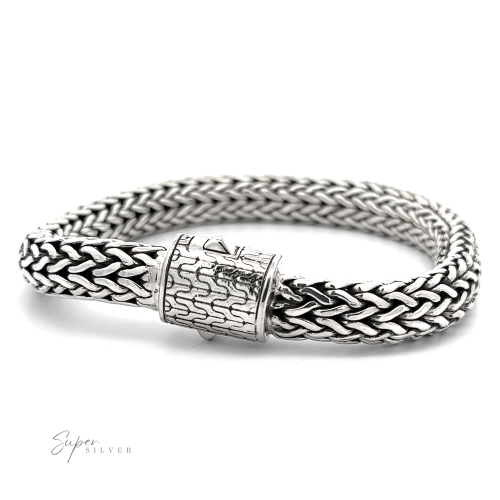 A woven Heavy Braided Bracelet with an intricate snap clasp, featuring a contrasting pattern and texture. The brand name 